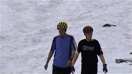 Michael and Olly return to the bikes after the final snow slide of the day, 10.9 miles into the ride
